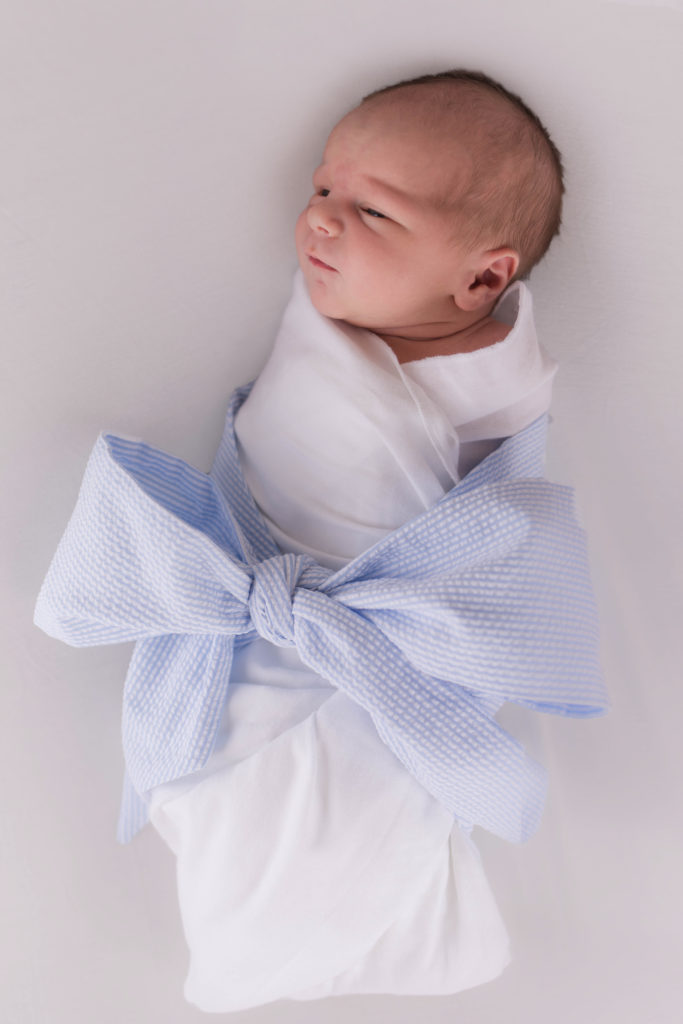 Newborn baby boy white backdrop with seersucker bow by Cincinnati Hyde Park Photographer
